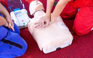 First aid and CPR class using automated external defibrillator device - AED - obrazy, fototapety, plakaty