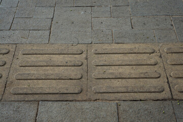 Tactile paving for blind handicap on sidewalk. Walkway for blindness people.           