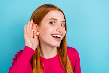 Photo of shiny curious young woman wear pink shirt arm ear listening secrets smiling isolated blue...