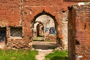 Old brick ruins with arches. Interior of an abandoned building