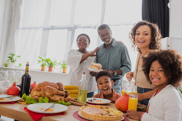 African american family with children standing near thanksgiving dinner