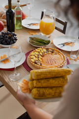 Cropped view of tasty thanksgiving dinner near blurred african american woman with corn