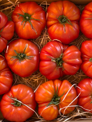Beef heart tomato in its basket in a rural farm shop in the south of france