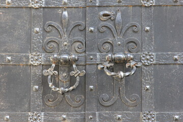 forged handles of the metal gate to the chapel