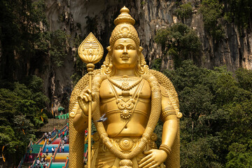 The huge statue Sri Muruga, the Hindu god of war, guards the access area to the Batu Caves, in the...