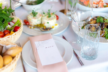 Menu mockup with glasses, flower fork, knife served for dinner in restaurant with cozy interior