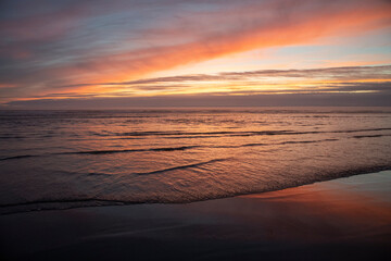 Sunset beach waves and clouds