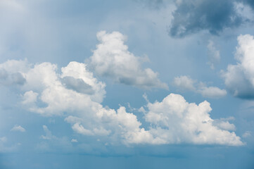 Fototapeta na wymiar A piece of sky with dramatic, voluminous, clouds.