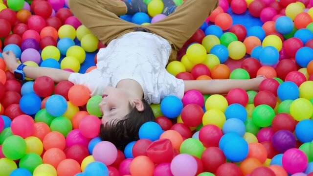 Autistic child in the pool with colored balls. Autism Spectrum Disorder