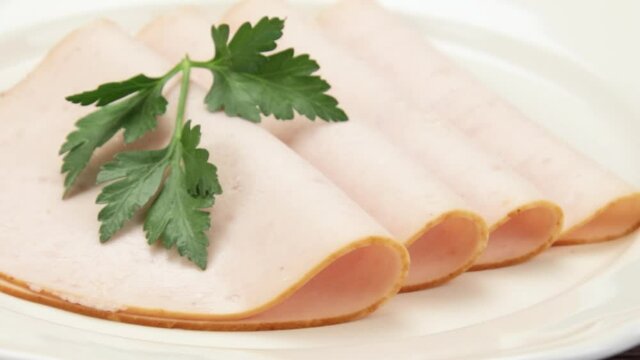slices of cooked chicken fillet on a plate