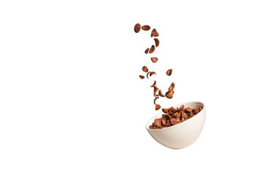 Chocolate corn flakes falling to the white bowl isolated on white. Motion.