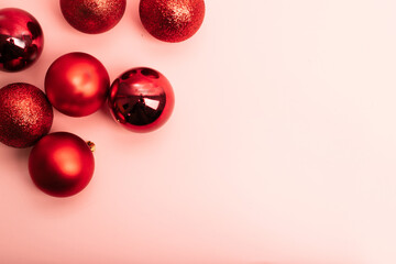 pink background framed with red Christmas balls