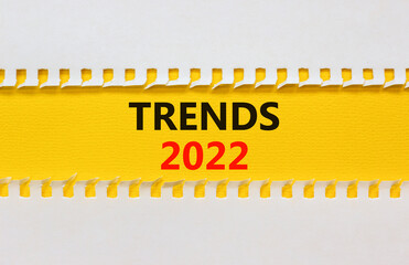 2022 trends new year symbol. White and yellow paper with words '2022 trends'. Beautiful yellow...