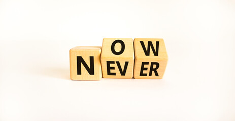 Now or never symbol. Turned wooden cubes and changed the word 'never' to 'now' or vice versa. Beautiful white background, copy space. Business and now or never planning concept.