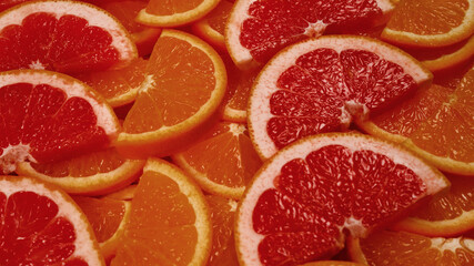 Slices of oranges and a grapefruits as a background.
