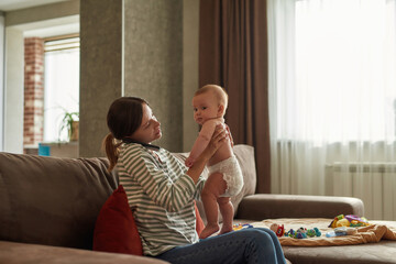 Woman while phone consultation with doctor looking at child