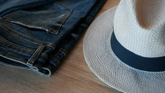 Closeup detail of a blue jeans trouser with elegant blue hat. Rotating. Abstract fashion background.