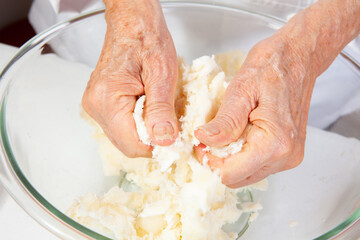 Preparation of a traditional Colombian fried  stuffed yucca dumplings called carimañolas