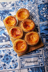 Portugal egg tart Pastel de Nata with azulejo tile pattern traycloth