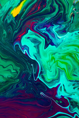Beautiful liquid texture of the nail polish.Green and purple colors.Multicolored background with copy space.Fluid art,pour painting technique.Good as digital decor,vertical photography.