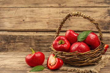 Ripe red round peppers in a handmade wicker basket