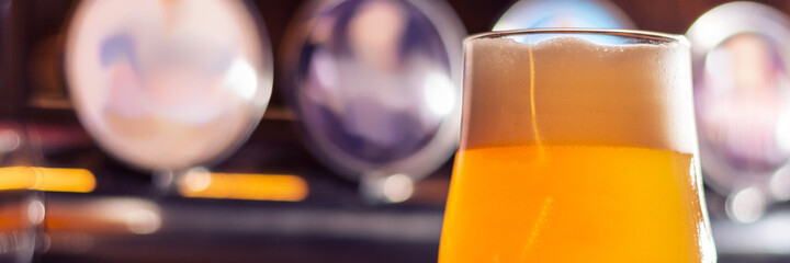 glass of fruit craft beer on bar table on blurred background panorama - obrazy, fototapety, plakaty