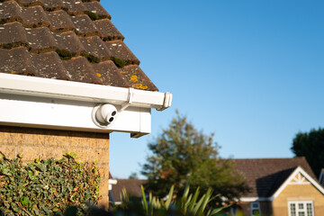 Newly installed, dome type night and day colour CCTV camera attached to the eaves of a private...