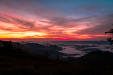 sunrise in a cold pasture red sky and beautiful clouds