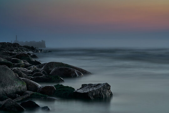 Amazing Perfect Dreamy Looking Sunset. Slow Shutter Speed Photos Of Sunset. Smooth Water And Colorful Clody Sky. Sunset Through Straws. Stones On The Beach. Wallpaper. Little Blur - Dreamy Look