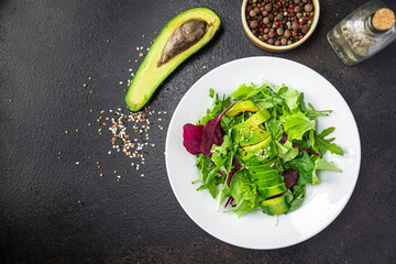avocado salad lettuce leaf mix spinach, arugula, chard, lettuce fresh meal snack on the table copy space food background rustic. top view keto or paleo diet veggie vegan or vegetarian food