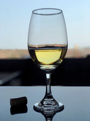 White wine in a glass overlooking the city