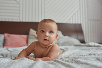 Sweet baby while tummy time in large cozy bed