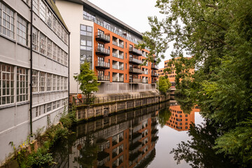 Norwich, Norfolk, UK – September 11 2021. A view of the riverside flats and apartments along the River Wensum captured from St George’s Bridge