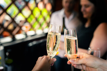 Friends raise glasses of champagne at a party