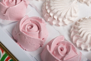 Homemade marshmallows of various shapes and colors are laid out on trays. Stabilization of Zephyr before packaging.