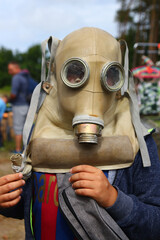 A boy in a wax gas mask