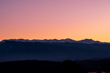 mountain range of peaks in the snow. mountains in the distance during dawn