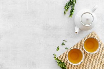 Asian food and drink background white teapot and black tea in two cups