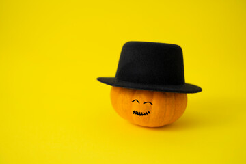 Pumpkin prepared for halloween on yellow background