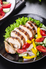 salad chicken breast meat poultry tomato, cucumber, onion, pepper, olive oil lettuce leaf mix fresh portion ready to eat meal snack on the table copy space food background rustic keto or paleo diet