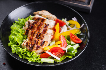 salad chicken breast meat poultry tomato, cucumber, onion, pepper, olive oil lettuce leaf mix fresh portion ready to eat meal snack on the table copy space food background rustic keto or paleo diet