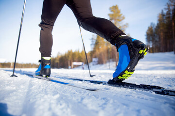 Winter sports competitions, boots and sticks cross of country skis glide on fresh snow