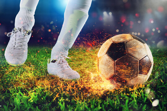 Soccer player ready to kick the fiery soccerball at the stadium