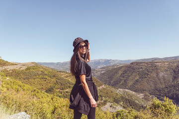 Young woman with hat enjoying the beautiful high mountain view .Bov Village, Balkan Mountain, Iskar Gorge