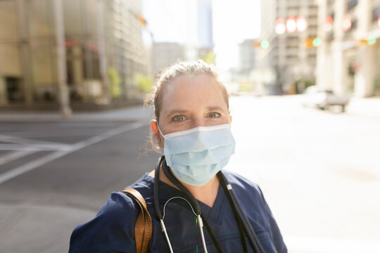 Portrait Of Nurse Wearing Facemask In City Center