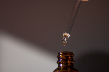 A dropper with oil and a bottle