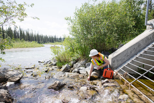 Environmental Inspector Checking Water Quality In River