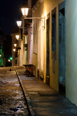 Old cobblestone street with colonial houses lit at night in the Pelourinho district of Salvador, Bahia.