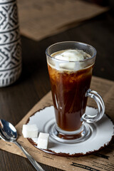 glass glass of coffee with ice cream on a wooden table