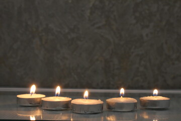 five small candles burn and stand in a triangle. side view. Divination Halloween Mystic